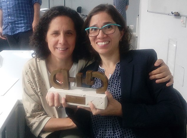 Catalina Devandas y Ana Peláez cogiendo juntas el premio CERMI otorgado a la Relatora de Naciones Unidas